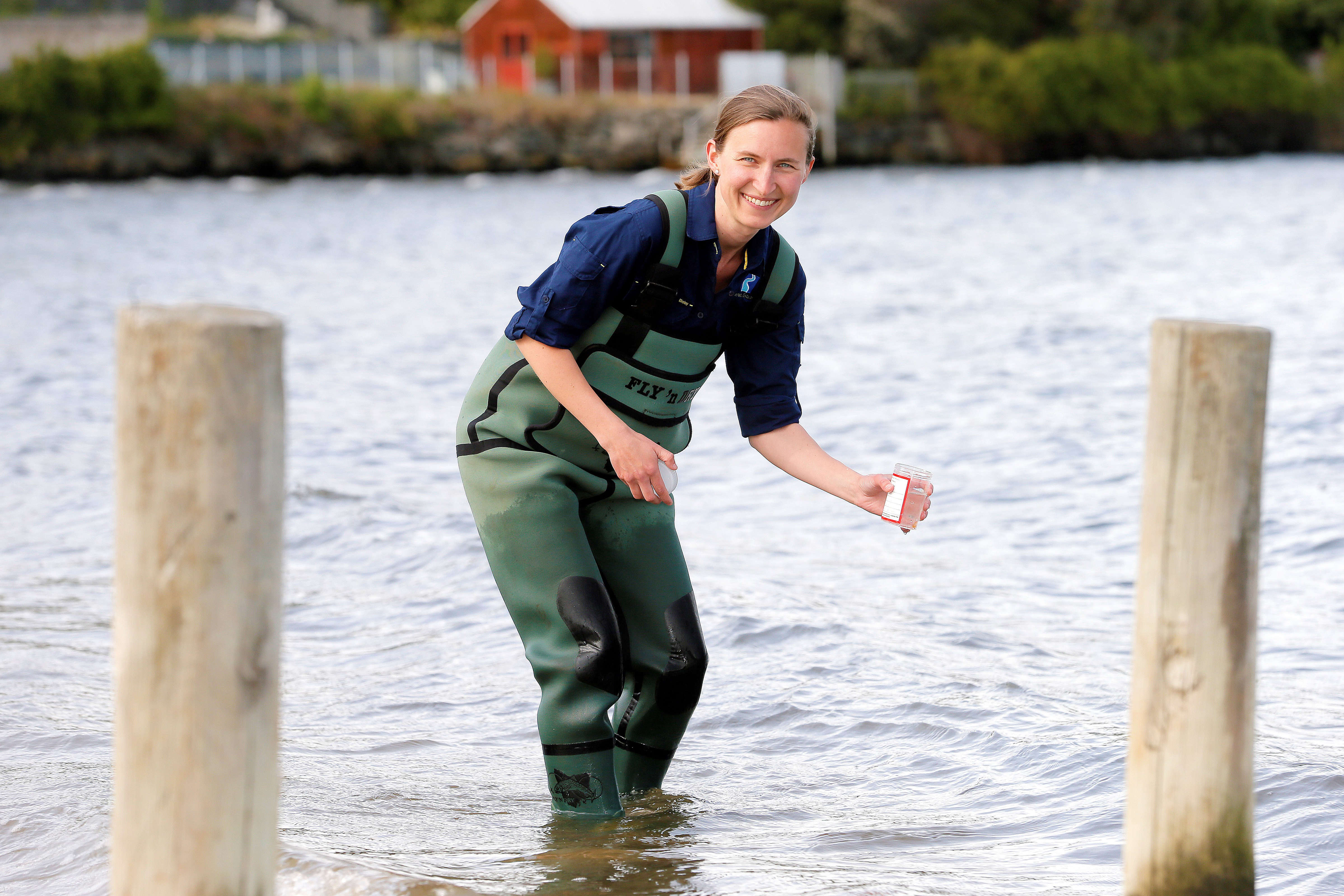 Bernadette Proemse in waders collecting a water sample in Sandy Bay (Marieville Esplanade). Photo: M. Thompson.